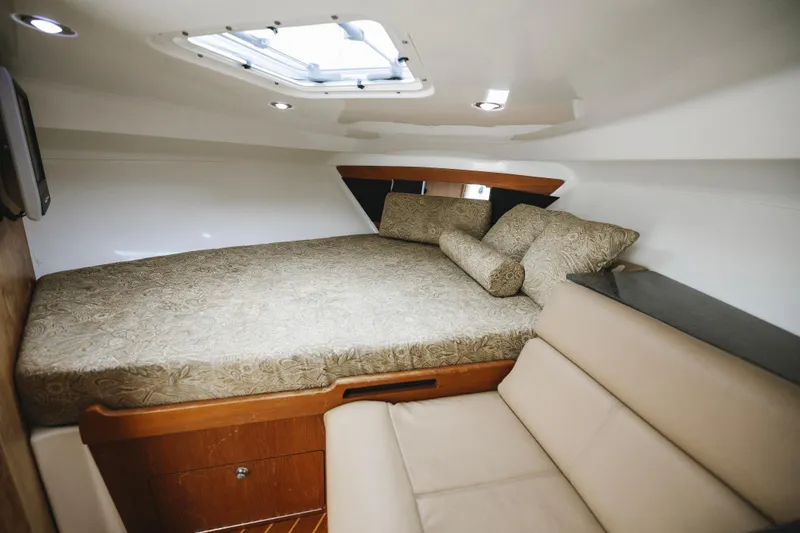 Slide: The Image of Luxurious cabin interior of 2008 Everglades 350LX boat with comfortable bedding and seating. - 16