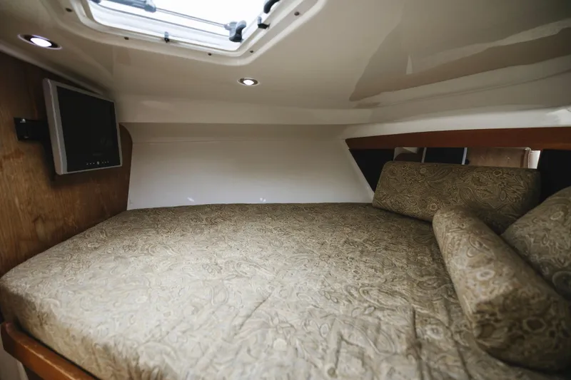 Slide: The Image of Interior cabin of 2008 Everglades 350LX boat with bed and TV. - 17