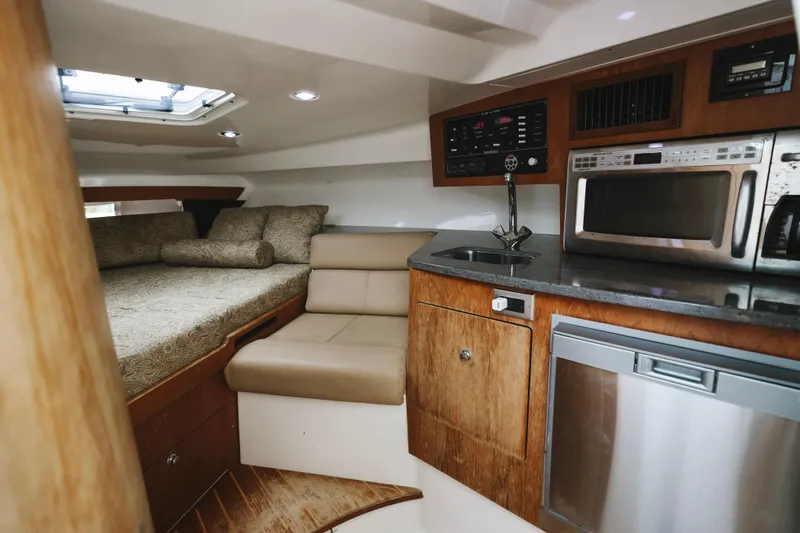 Slide: The Image of 2008 Everglades 350LX cabin interior with kitchenette, bed, and modern amenities. - 18