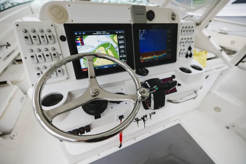 Slide: The Image of Helm of 2008 Everglades 350LX boat with navigation screens and controls. - 24