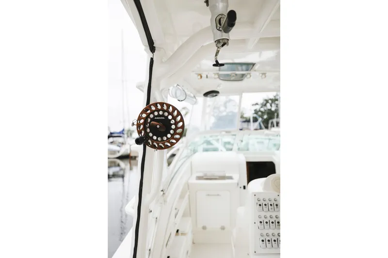 Slide: The Image of 2008 Everglades 350LX boat interior with fishing reel and control panel. - 29