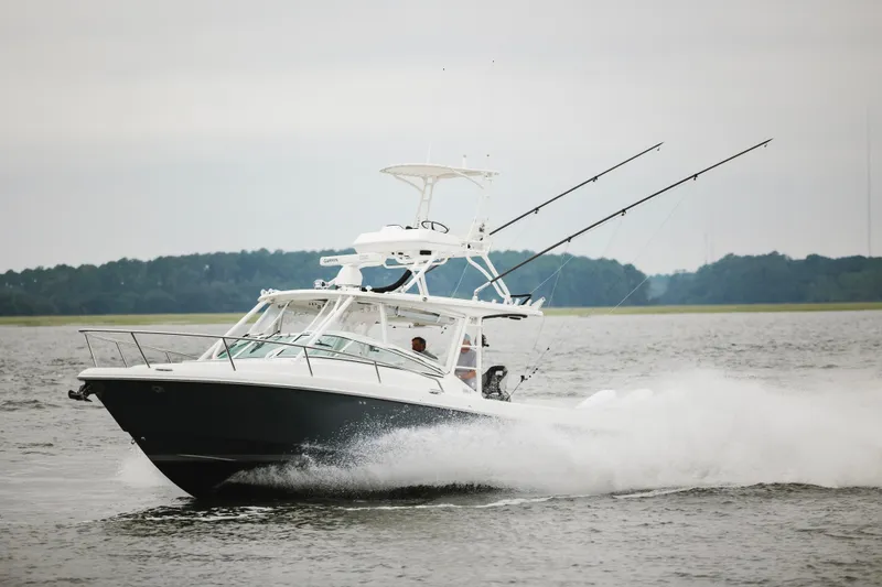 Slide: The Image of 2008 Everglades 350LX boat cruising on a lake with fishing rods. - 3