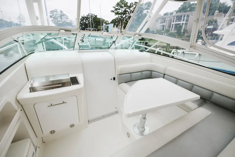 Slide: The Image of 2008 Everglades 350LX boat interior with seating and table, featuring sleek design. - 30