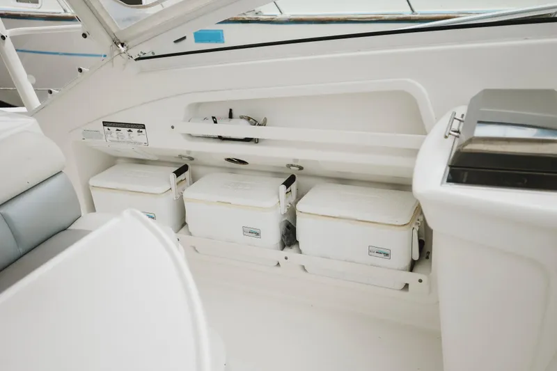 Slide: The Image of Interior of 2008 Everglades 350LX boat with storage compartments and coolers. - 34