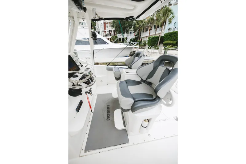 Slide: The Image of 2008 Everglades 350LX boat interior with dual gray seats and steering console. - 38