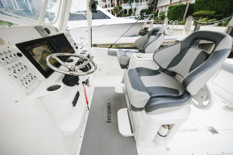 Slide: The Image of 2008 Everglades 350LX boat interior with steering wheel, navigation screens, and cushioned seats. - 39