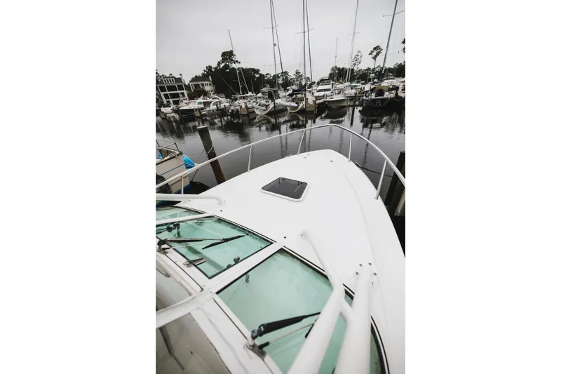 Slide: The Image of 2008 Everglades 350LX boat docked in a marina with surrounding yachts. - 45