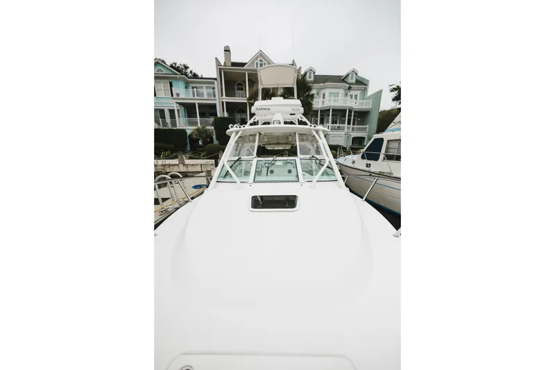 Slide: The Image of 2008 Everglades 350LX boat docked near waterfront homes. - 46