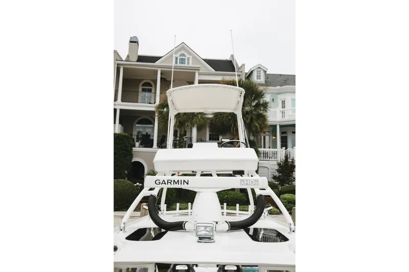 Slide: The Image of 2008 Everglades 350LX boat with Garmin equipment, docked near elegant houses. - 47