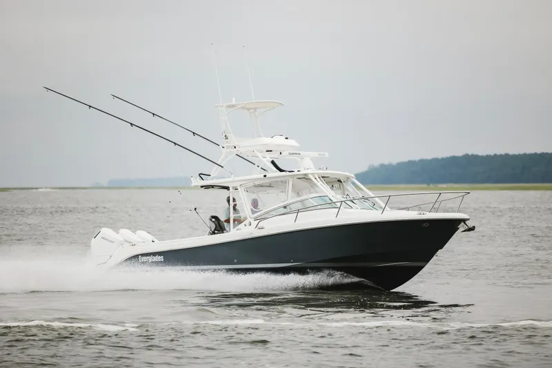 Slide: The Image of 2008 Everglades 350LX boat cruising on open water with fishing rods. - 5