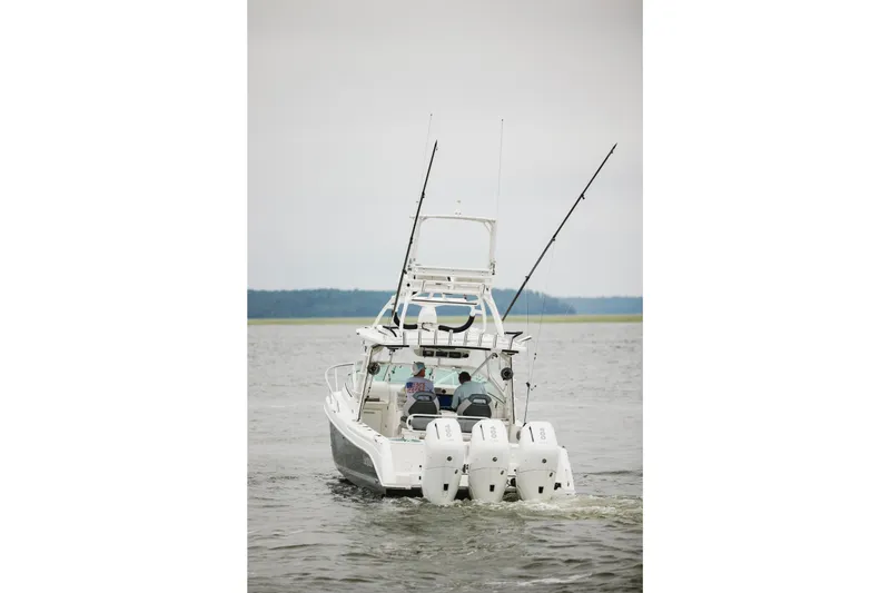 Slide: The Image of 2008 Everglades 350LX boat with triple engines on open water. - 6