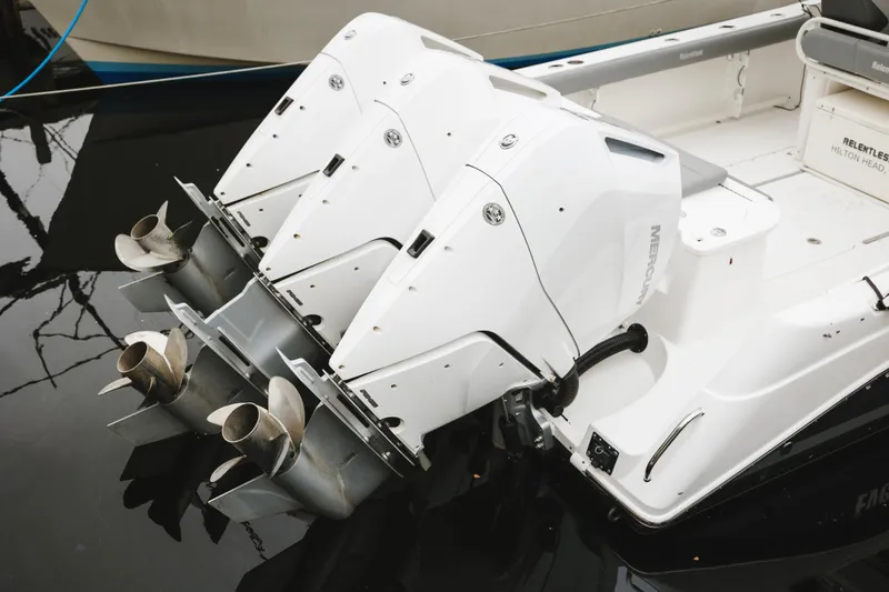 Slide: The Image of 2008 Everglades 350LX boat with triple Mercury outboard engines, docked in water. - 8