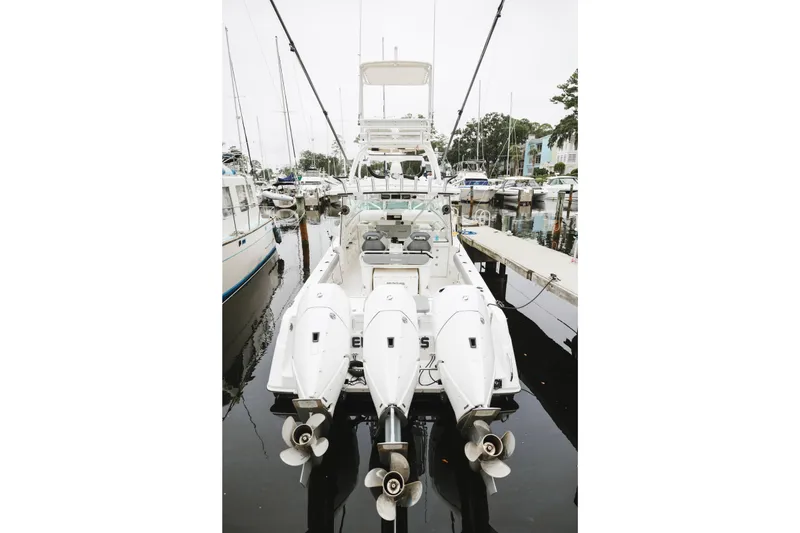 Slide: The Image of 2008 Everglades 350LX boat with triple outboard engines docked at marina. - 9
