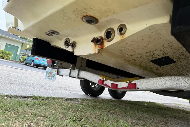 Slide: The Image of Underside of 2006 ShearWater Z2200 boat on trailer, showing rust and wear. - 10