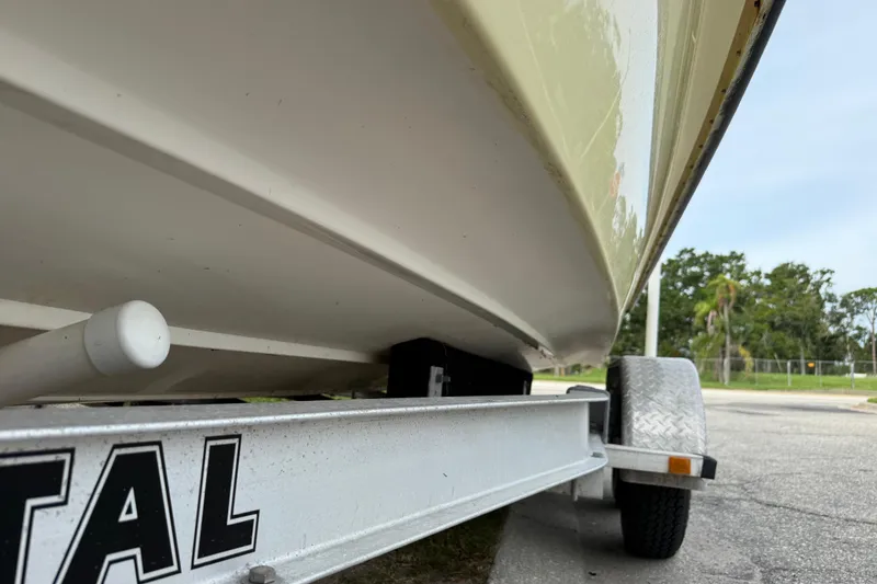 Slide: The Image of 2006 ShearWater Z2200 boat on trailer, close-up view of hull and wheel. - 14
