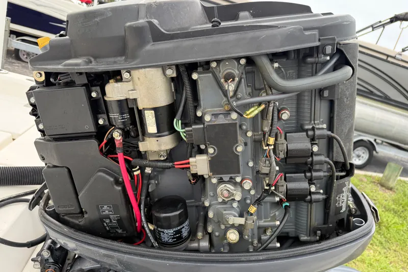 Slide: The Image of Close-up of a 2006 ShearWater Z2200 boat engine with visible wiring and components. - 17