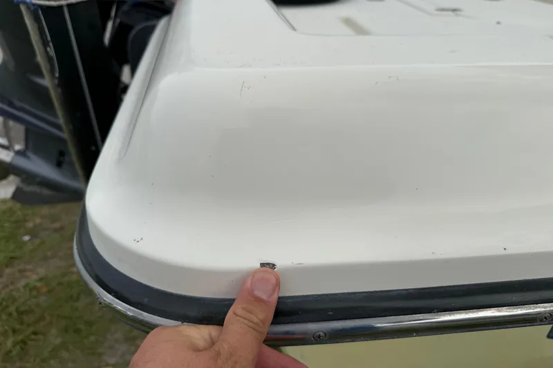 Slide: The Image of Close-up of a 2006 ShearWater Z2200 boat corner with minor damage. - 18