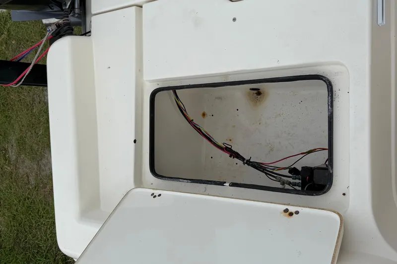 Slide: The Image of Open compartment of 2006 ShearWater Z2200 boat showing wiring and interior details. - 22