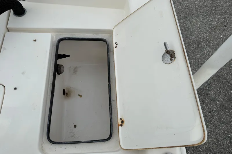 Slide: The Image of Open storage compartment on a 2006 ShearWater Z2200 boat, showing interior details. - 24