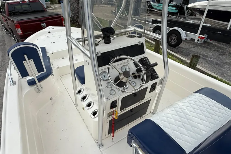 Slide: The Image of 2006 ShearWater Z2200 boat interior with steering console and seating. - 28