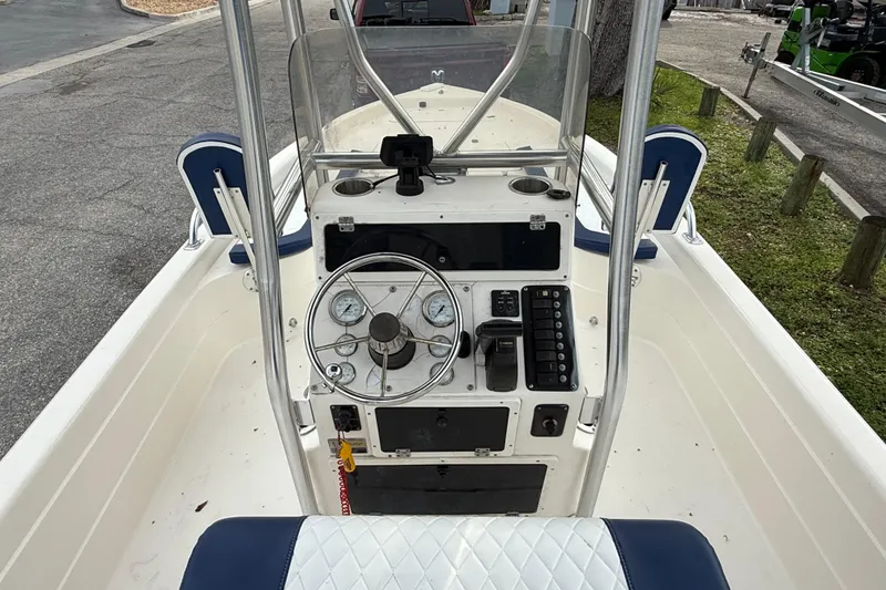 Slide: The Image of 2006 ShearWater Z2200 boat console with steering wheel and control panel. - 29