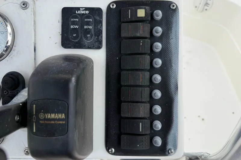 Slide: The Image of Control panel of a 2006 ShearWater Z2200 boat with Yamaha remote and Lenco switches. - 33
