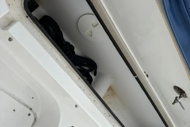Slide: The Image of Storage compartment on a 2006 ShearWater Z2200 boat with coiled rope inside. - 36