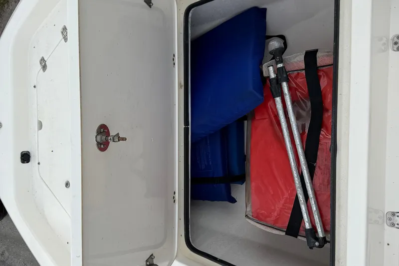 Slide: The Image of Storage compartment of a 2006 ShearWater Z2200 boat with safety equipment. - 37