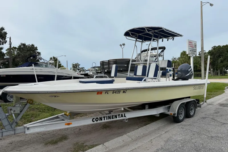Slide: The Image of 2006 ShearWater Z2200 boat on trailer, parked outdoors with Yamaha engine. - 4