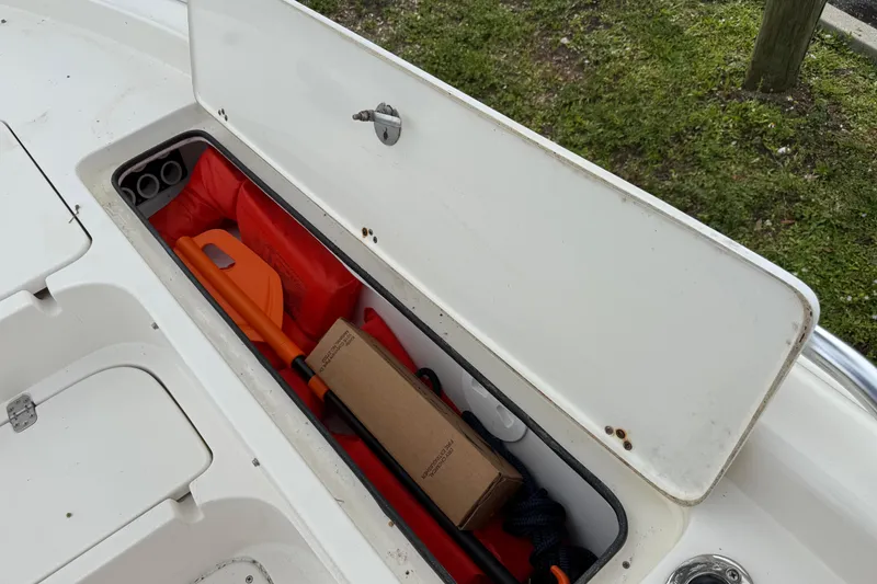 Slide: The Image of Open storage compartment on 2006 ShearWater Z2200 boat with safety equipment. - 40