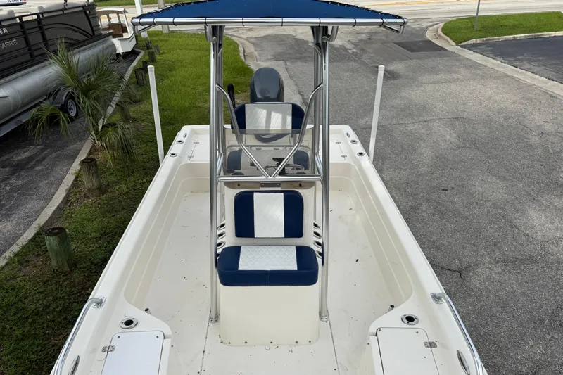 Slide: The Image of 2006 ShearWater Z2200 boat with blue seating and canopy, parked on pavement. - 41