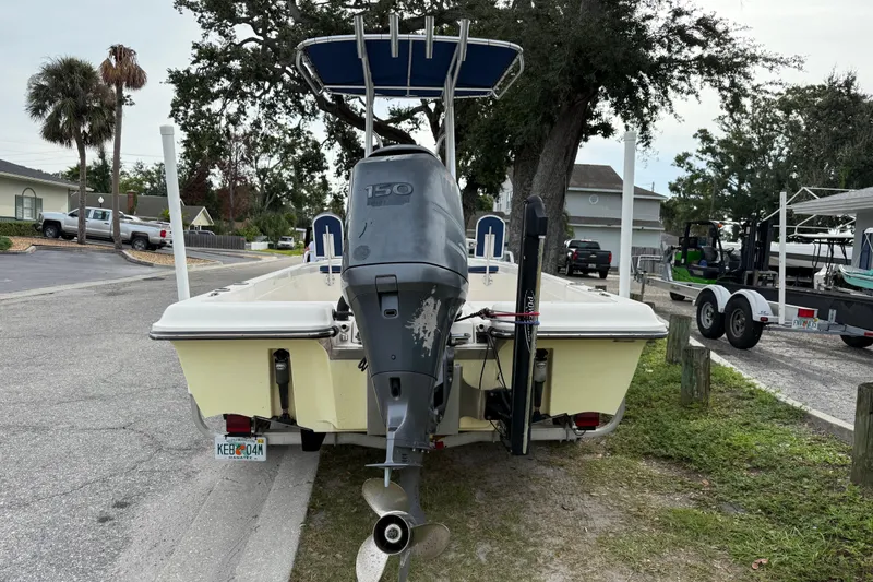 Slide: The Image of 2006 ShearWater Z2200 boat with outboard motor parked on a residential street. - 6
