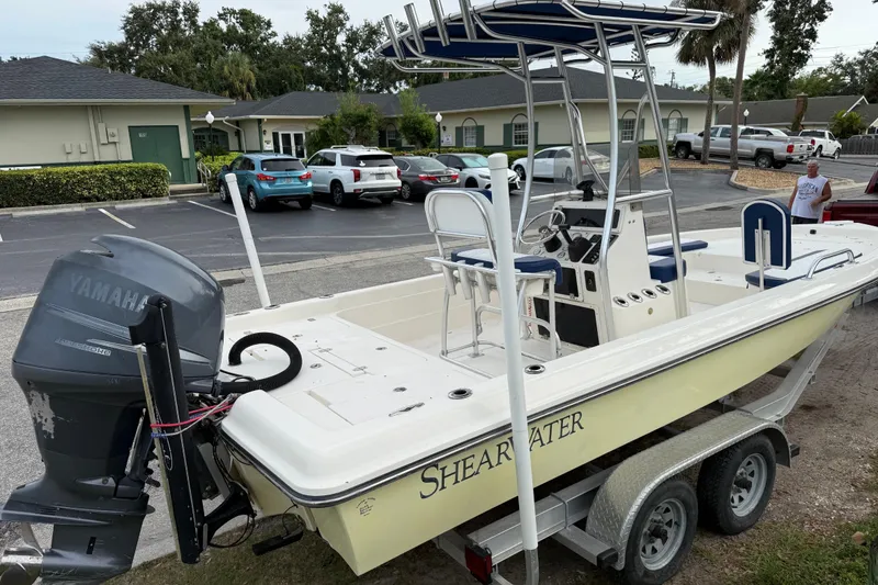 Slide: The Image of 2006 ShearWater Z2200 boat on trailer with Yamaha outboard motor in parking lot. - 7