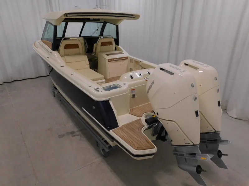 Slide: The Image of 2024 Chris-Craft Calypso 32 boat with dual outboard engines in showroom. - 3
