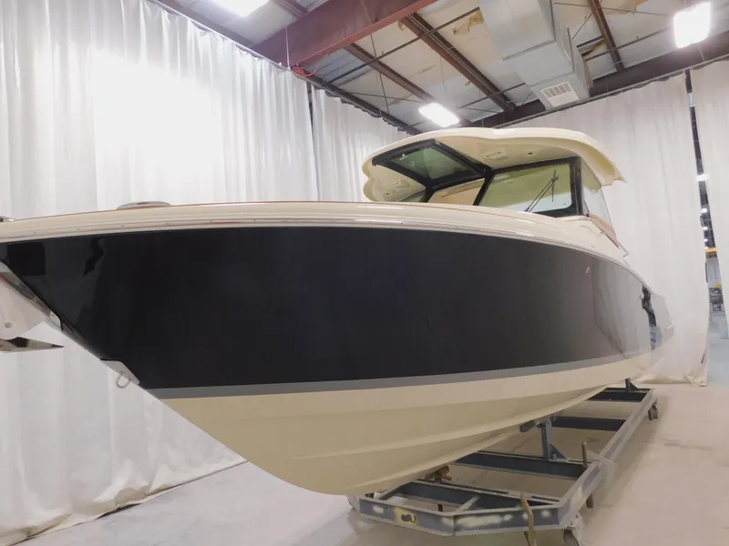 Slide: The Image of 2024 Chris-Craft Calypso 32 boat in a showroom. - 7