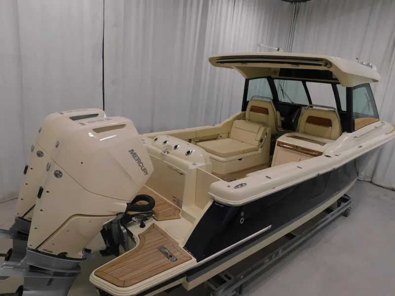 Slide: The Image of 2024 Chris-Craft Calypso 32 boat with twin Mercury outboard engines in a showroom. - 9