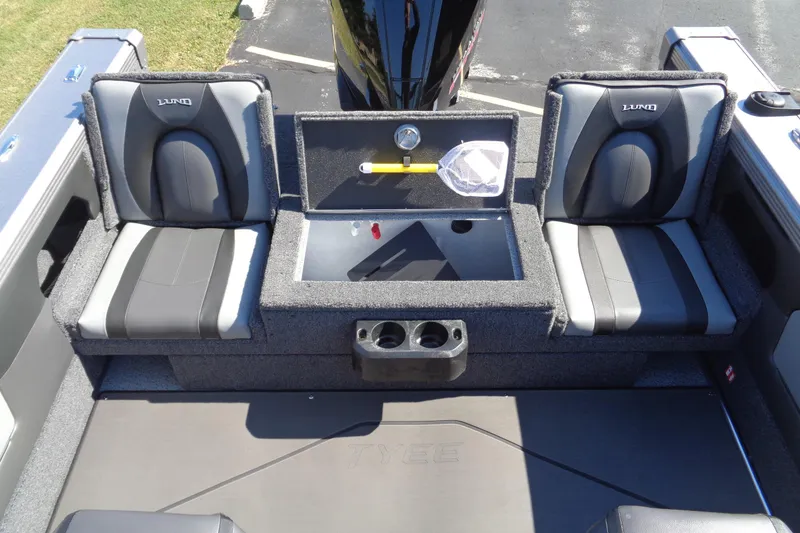 Slide: The Image of 2026 Lund 1975 Tyee boat interior with cushioned seats and storage compartments. - 12