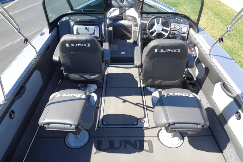 Slide: The Image of Interior of 2026 Lund 1975 Tyee boat with branded seating and steering console. - 13