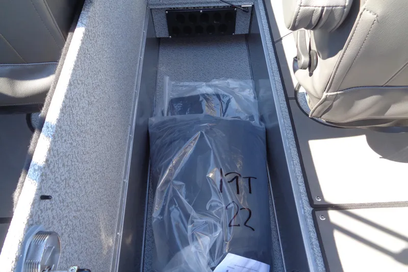 Slide: The Image of Storage compartment in a 2026 Lund 1975 Tyee boat, featuring a packaged item. - 15
