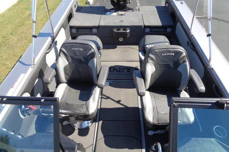 Slide: The Image of 2026 Lund 1975 Tyee boat interior with two black seats and spacious layout. - 19