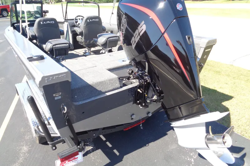 Slide: The Image of 2026 Lund 1975 Tyee boat with powerful outboard motor, featuring spacious seating and modern design. - 30