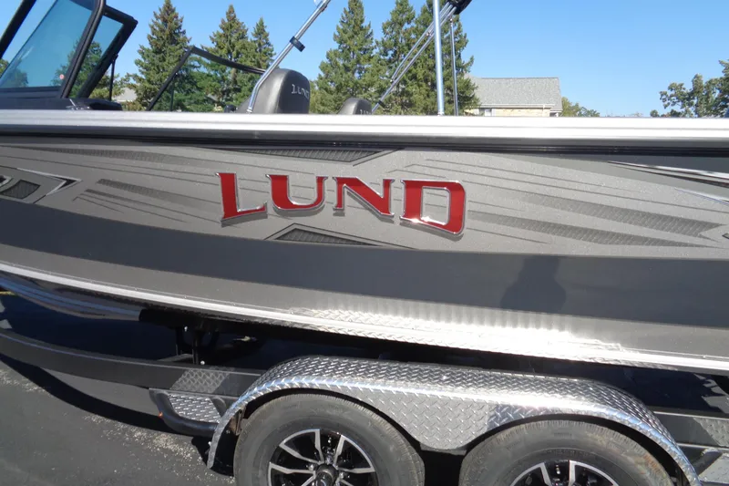Slide: The Image of Lund 1975 Tyee 2026 boat on trailer, featuring sleek design and bold logo. - 32