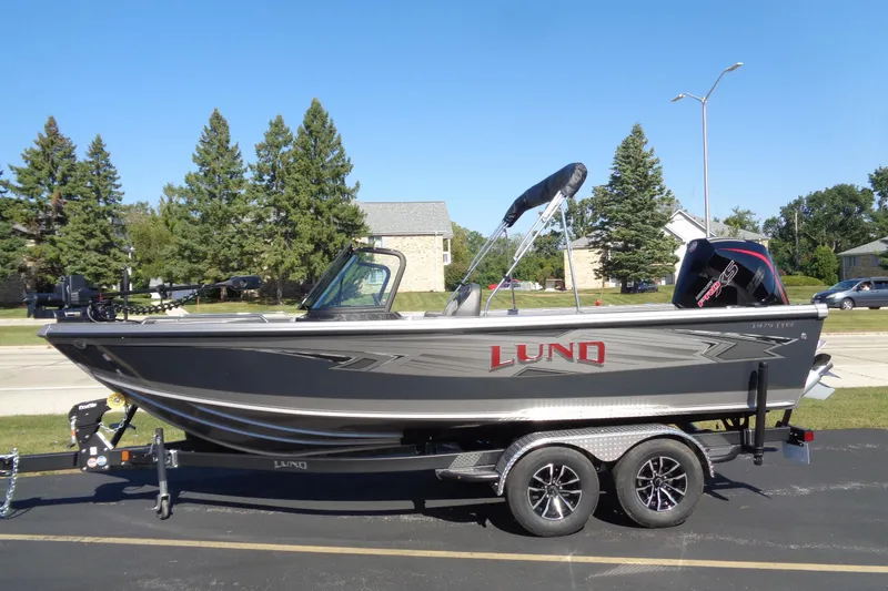 Slide: The Image of 2026 Lund 1975 Tyee boat on trailer, parked outdoors, sunny day. - 33