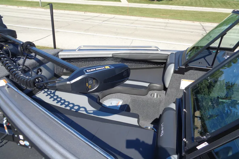 Slide: The Image of 2026 Lund 1975 Tyee boat interior with Minn Kota trolling motor, gray seating, and windshield. - 5