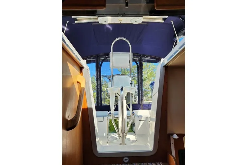 Slide: The Image of Interior view of a 2006 Hunter 33 sailboat cockpit with blue canopy. - 10