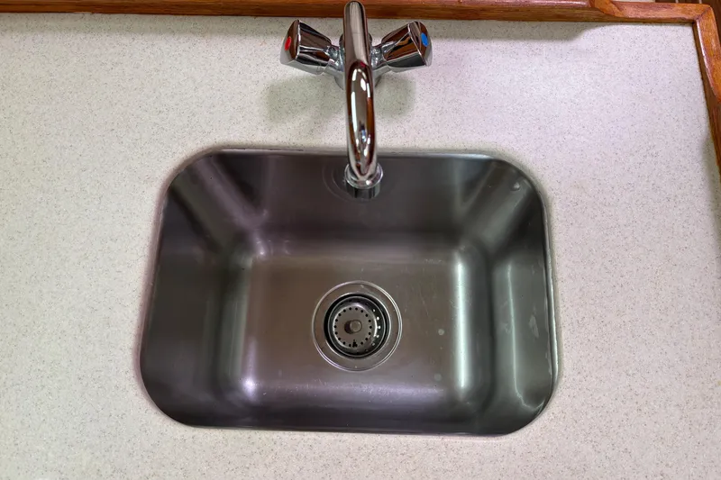 Slide: The Image of Stainless steel sink with chrome faucet on a Hunter 33, 2006 model. - 15