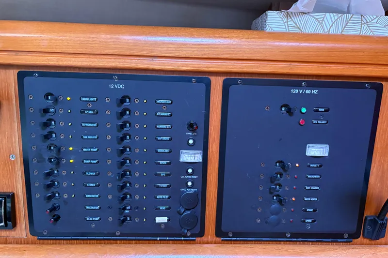 Slide: The Image of Electrical control panel on a 2006 Hunter 33 sailboat, featuring 12VDC and 120V/60Hz systems. - 26