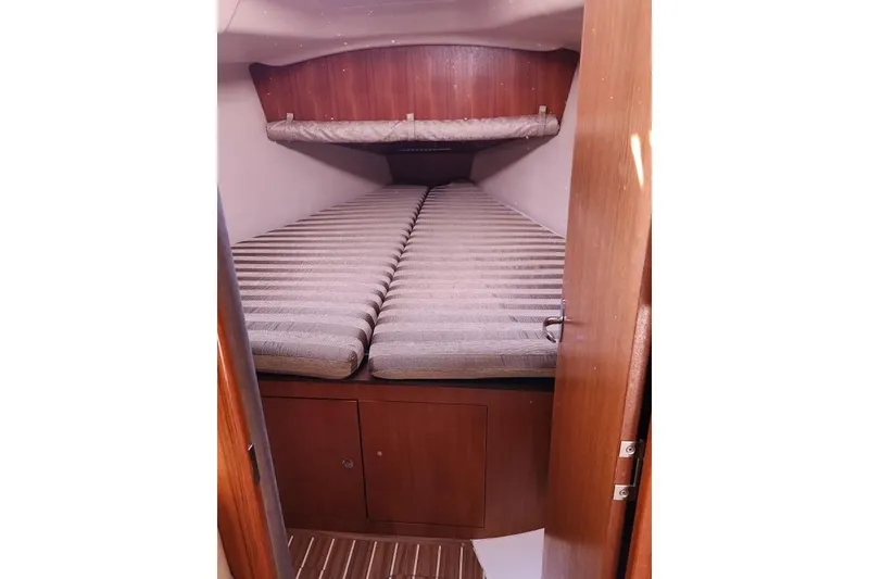 Slide: The Image of Cozy cabin interior of 2006 Hunter 33 sailboat with striped bedding. - 27