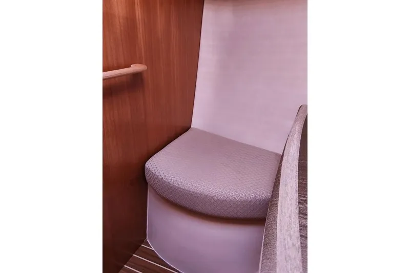 Slide: The Image of Interior seating area of a 2006 Hunter 33 sailboat with wooden accents. - 28