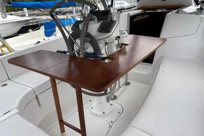 Slide: The Image of Cockpit of 2006 Hunter 33 sailboat with wooden table and steering wheel. - 5